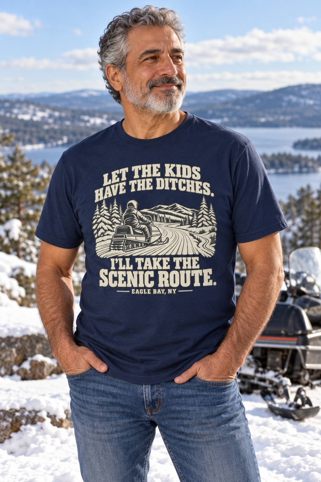 Arab man wearing the navy Eagle Bay Scenic Route vintage snowmobile tee at a snowy Adirondack overlook