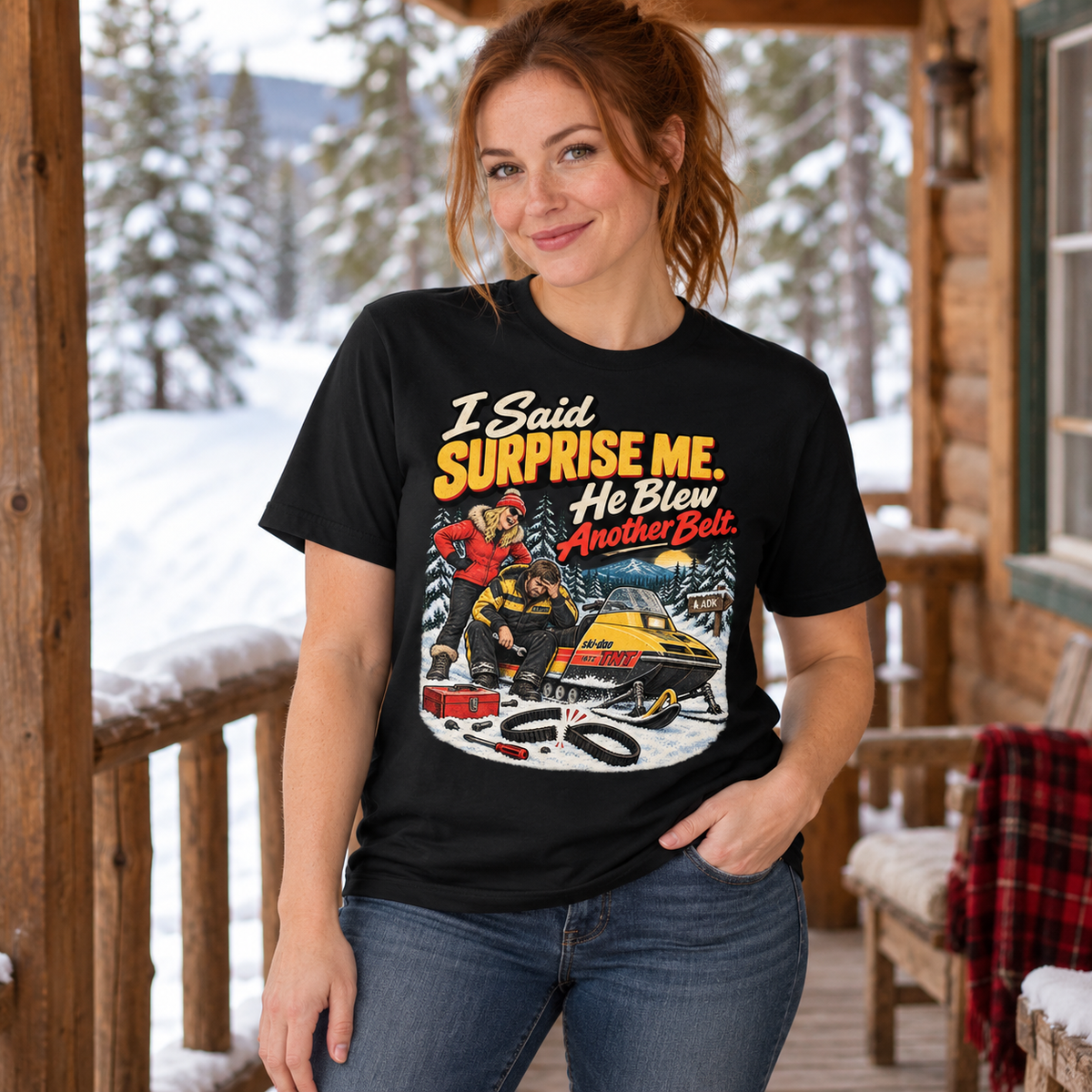 Woman wearing I Said Surprise Me He Blew Another Belt tee on a snowy cabin porch