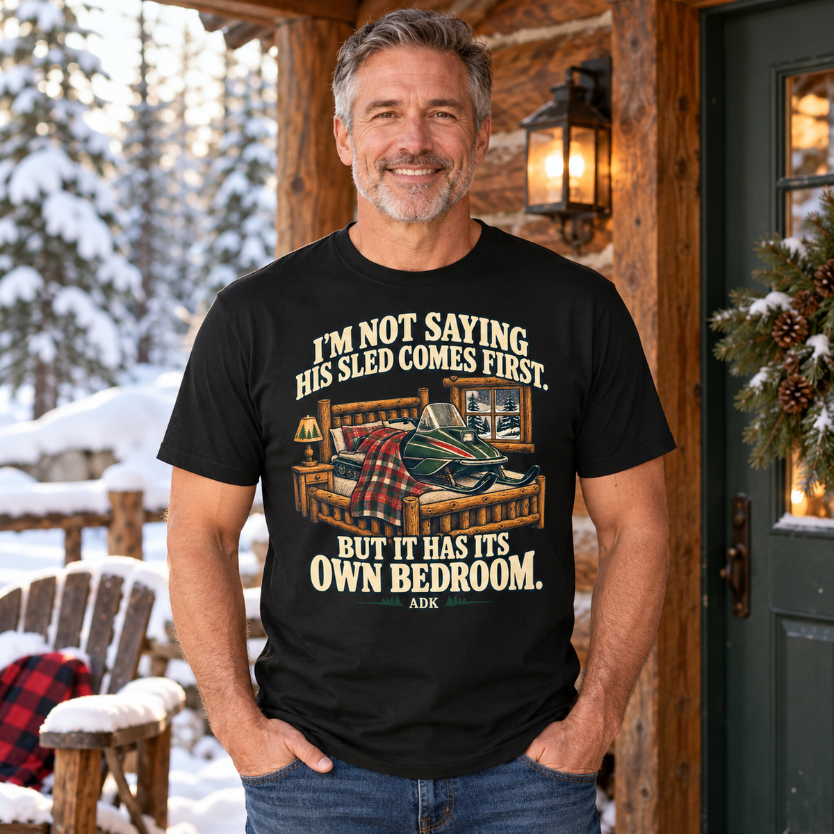 Man in his 50s wearing the snowmobile bedroom tee at a snowy cabin