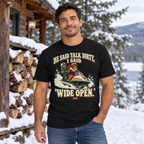 Man wearing the Wide Open snowmobile tee beside a snowy cabin