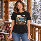 Woman wearing the Inlet snowmobile tee on a winter cabin porch