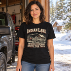 Woman wearing Indian Lake Where Everybody Knows Your Truck tee beside a pickup